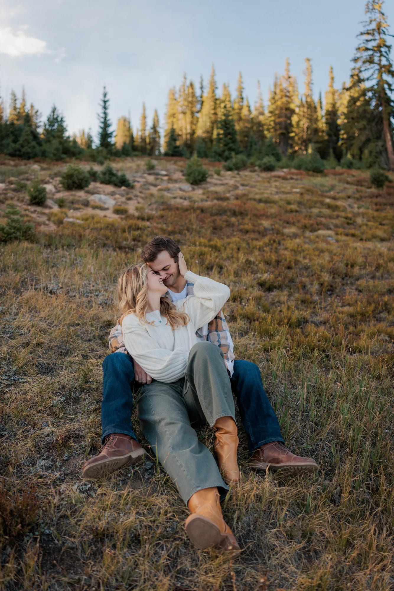 Jordan and Daelynn sitting together in a golden meadow